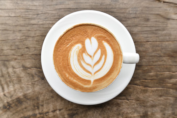 Coffee cup with latte art foam on wood table in coffee shop with copy space.Coffee is one of the most popular beverages.Improve Energy Levels and Burn Fat