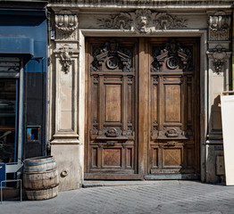 Old wooden door. Gorgeous antique double door entrance of baroque architecture style building in...