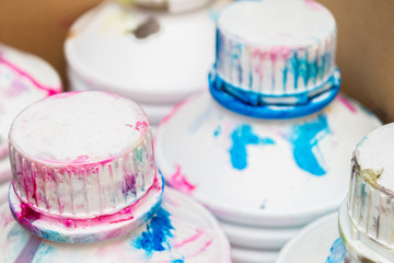 dirty cans in a multi-colored printer ink