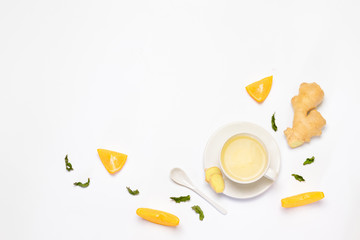 Creative layout made of cup of hot tea with ginger and lemon on a white background. Top view