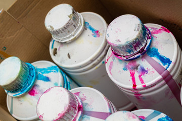 dirty cans in a multi-colored printer ink