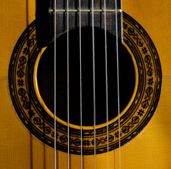 Obraz premium The strings and the fretboard of a spanish acoustic guitar 