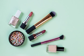 Flat lay composition with makeup products on light green background.set of professional decorative cosmetics, makeup tools and accessory. beauty, fashion and shopping concept.Beauty flat lay