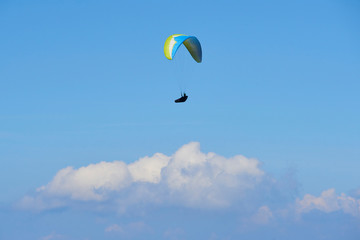 Paraglider flying over the Garda Lake (Lago di Garda or Lago Benaco), Panorama of the gorgeous Garda lake surrounded by mountains. Paragliding is very popular sport in Monte Baldo. Malcesine, Italy