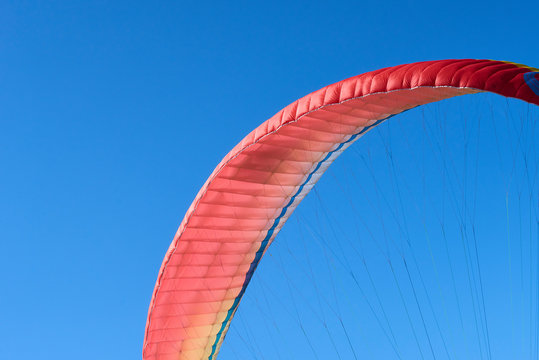 Detail of parachute (Fabric wing. Wing shape is maintained by the suspension lines) designed for paragliding with blue sky background