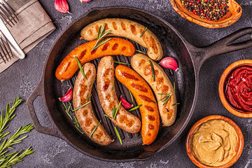 Grilled homemade sausages in a pan.