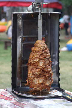 outdoor grill with meat on spitter