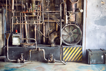 wall with iron Golden trumpets of communication and a large fan