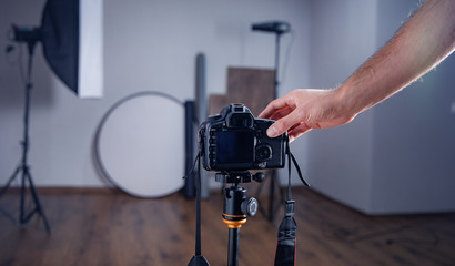 man photographer  hand camera in studio background