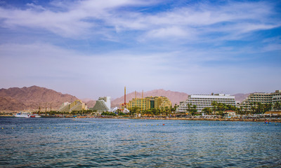 Obraz premium summer vacation destination photography of the most south Israeli city Eilat with hotel apartment buildings along Red sea beach with port scenic landscape place 