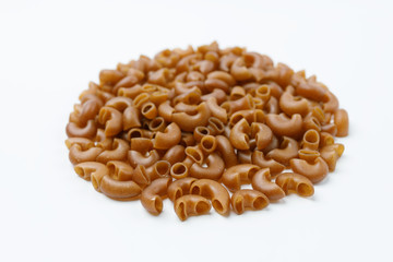 Small heap of pasta from buckwheat flour on a white background