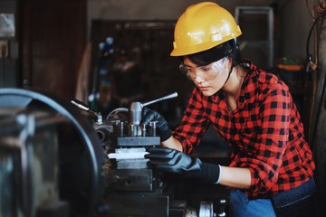 Smart Asian woman working in factory.