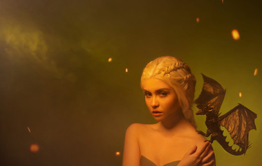 young woman with white braided hair and little dragon on shoulder. hostess of magical beasts with...