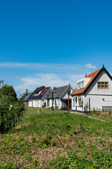 Fototapeta na wymiar Houses along dike, in place called Broek op Langedijk, The Netherlands