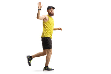 Bearded man jogging and waving