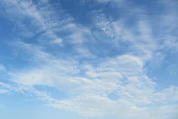 Naklejka na ściany i meble Beautiful blue sky with fluffy clouds, natural background
