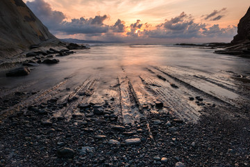 Sunset with its impacted rock formations on Itzurun beach (Zumaia, Basque country, Spain)