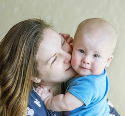 Mom kisses baby