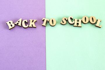 Colorful paper background. The inscription "back to school." The concept of holiday knowledge.