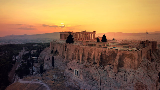 Aerial drone photo of iconic Acropolis hill and the unique masterpiece of Ancient world the Parthenon at sunset with beautiful golden colours, Athens historic centre, Attica, Greece © aerial-drone