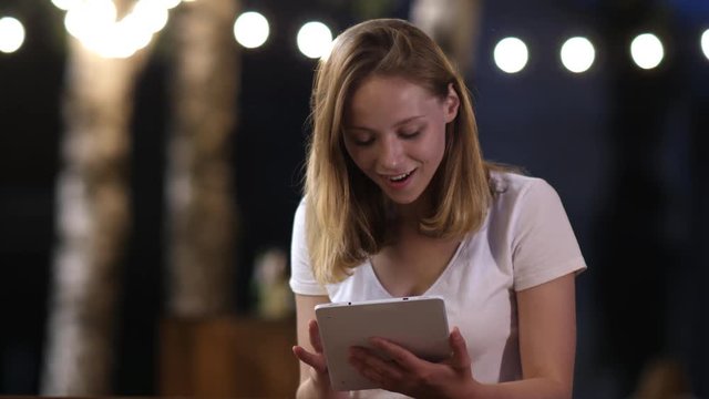 Young woman holding digital tablet feels amazement receiving great news, shopper getting big discount, celebrating online lottery win, motivated by victory achieve succeed goal concept.