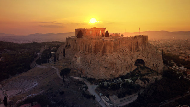 Aerial drone photo of iconic Acropolis hill and the unique masterpiece of Ancient world the Parthenon at sunset with beautiful golden colours, Athens historic centre, Attica, Greece © aerial-drone