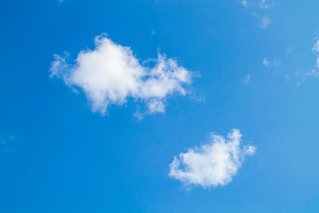 white clouds against the blue sky.