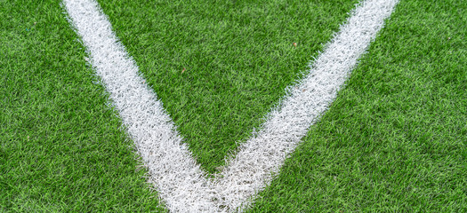 Fototapeta premium Green artificial grass soccer sports field with white stripe line