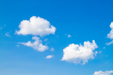 white clouds against the blue sky.