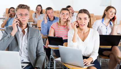 Fototapeta premium Young people talking on phones