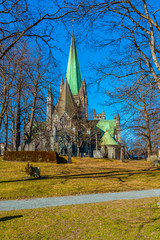 Nidaros cathedral in Trondheim viewed behind a park, Norway
