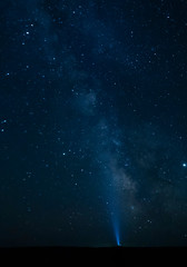 Torch light pointing to the Milky Way - Gobi Desert, Mongolia