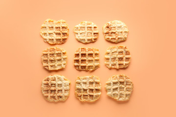 Tasty waffles on color background