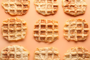Tasty waffles on color background