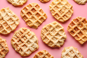 Tasty waffles on color background