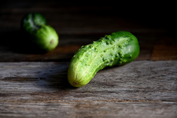 Cucumbers on an old wooden table.