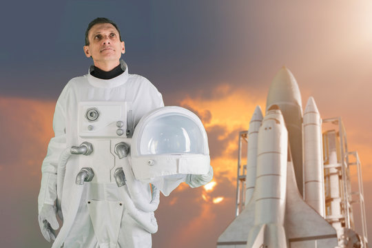 astronaut holding helmet space suit and smiling - Powered by Adobe