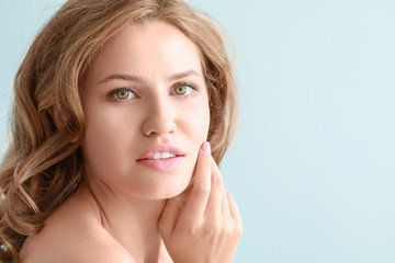 Fototapeta premium Beautiful young woman on color background