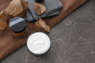 Jar of natural cream and chocolate on dark background