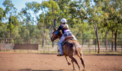 Horse And Rider Competing In Barrel Race At Outback Country Rodeo