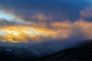 Sunset in mountain and misty terrain of Iceland.