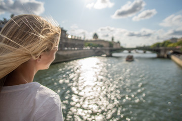 Fototapeta na wymiar Girl watching Boats on Seine, Paris