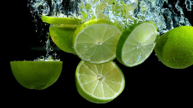 Super slow motion of falling lime pieces into splashing water. Filmed on high speed cinema camera, 1000 fps.