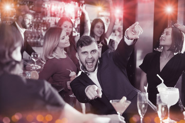 Guy expressively dancing in bar