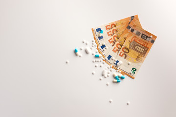 Euro bank notes and pill isolated on white background