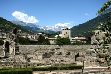 Fototapeta na wymiar The Roman remains of the city of Aosta and in the background the Mont Blanc - Italy