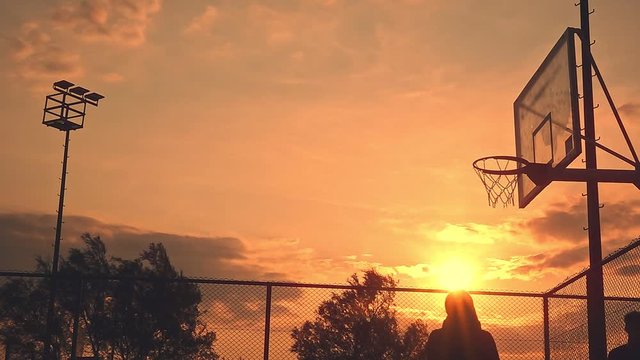 Basketball Layup captures a silhouette of a basketball player making a layup.