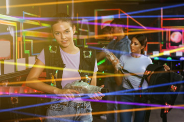 Obraz premium people looking laser guns and clothes together