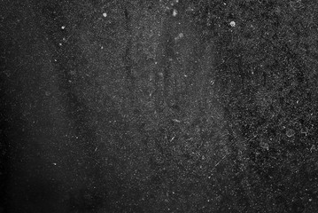 white dust and scratches on a black background. The texture of dirt on the glass.