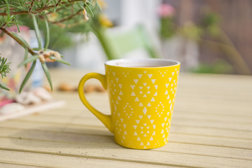 Summer inspirations - monochrome. Closeup of a yellow glass with aromatic coffee wood background. Shallow depth of focus.space